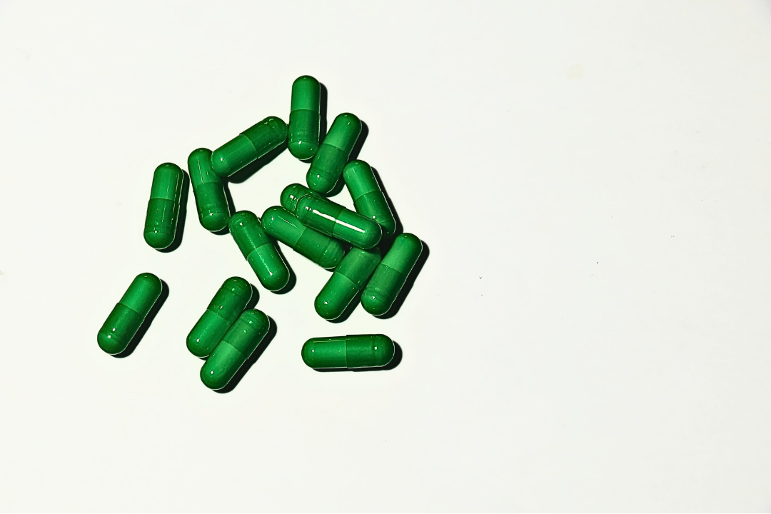 Heritage of Care Professional Placenta Capsules – Premium green gelatin capsules containing encapsulated placenta for postpartum wellness